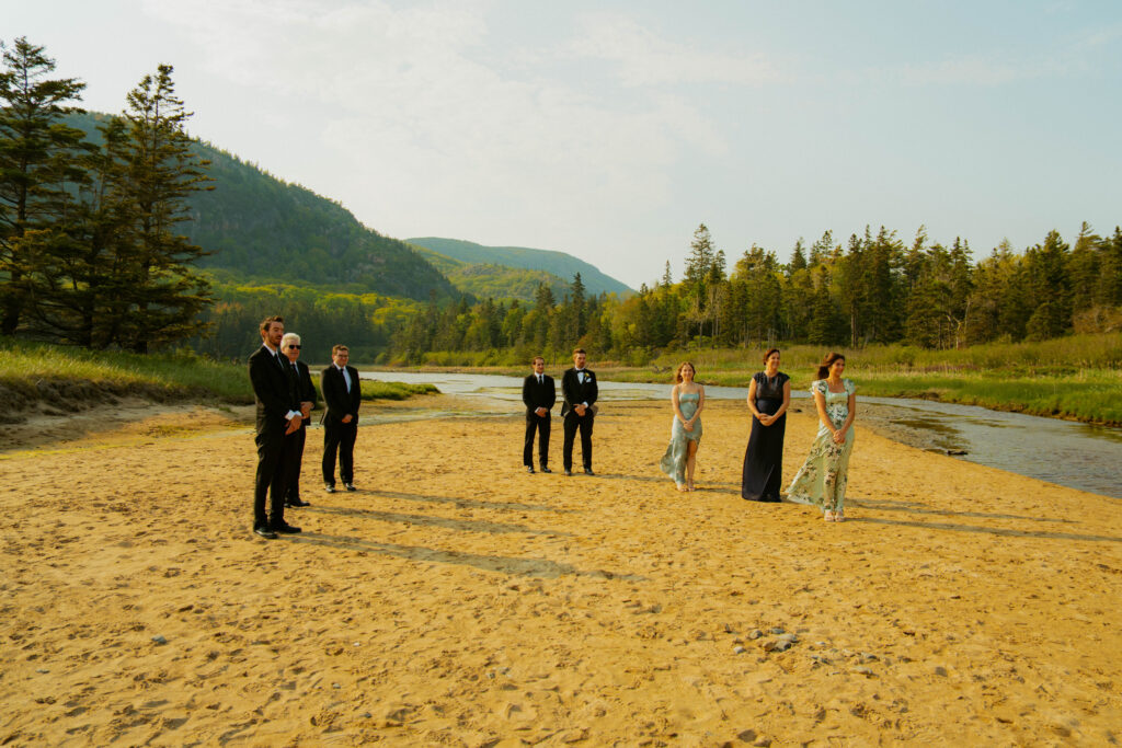 family waiting on the beach for a wedding ceremony in acadia national park